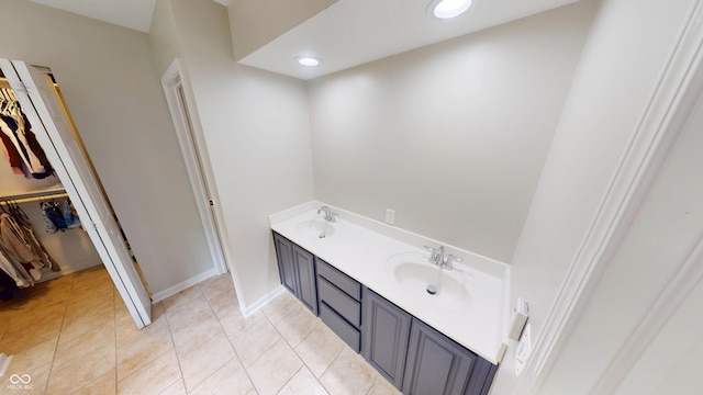 9831 Deering St, Fishers, IN 46037 - bathroom with a walk in closet, double vanity, and tile patterned flooring