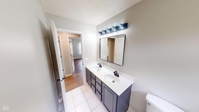 9831 Deering St, Fishers, IN 46037 - bathroom featuring double vanity, tile patterned floors, and a textured ceiling