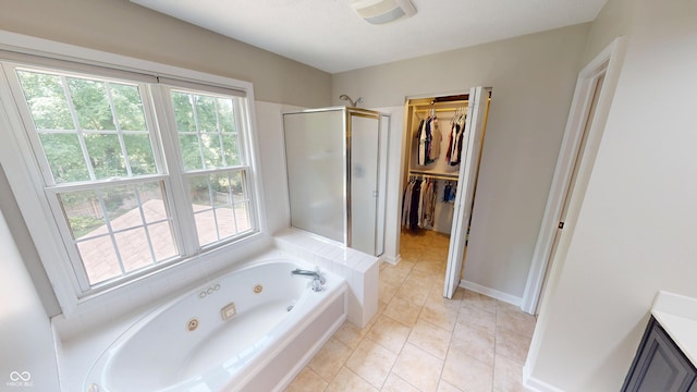 9831 Deering St, Fishers, IN 46037 - full bathroom featuring a stall shower, a tub with jets, vanity, a walk in closet, and tile patterned floors