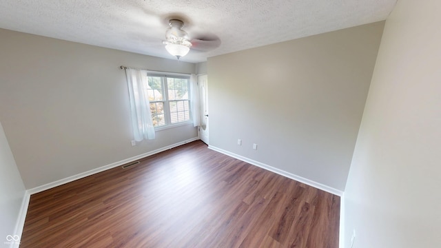 9831 Deering St, Fishers, IN 46037 - empty room featuring dark wood-type flooring, a textured ceiling, and a ceiling fan