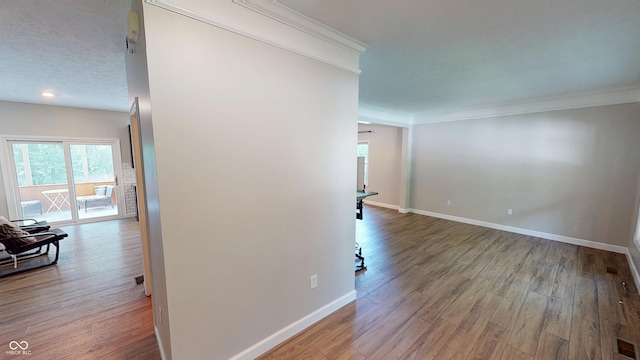 9831 Deering St, Fishers, IN 46037 - hallway featuring crown molding, wood finished floors, and recessed lighting