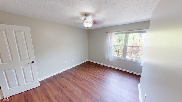 9831 Deering St, Fishers, IN 46037 - empty room with wood finished floors and a textured ceiling