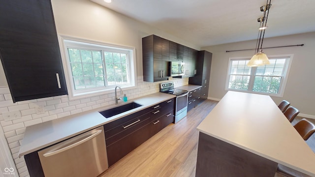 9831 Deering St, Fishers, IN 46037 - kitchen with stainless steel appliances, modern cabinets, decorative backsplash, and light countertops