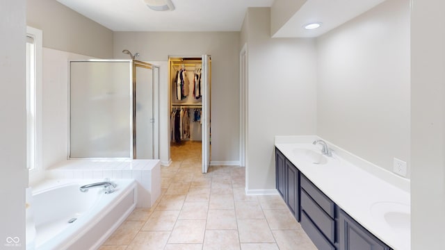 9831 Deering St, Fishers, IN 46037 - full bath featuring a stall shower, double vanity, a garden tub, a walk in closet, and tile patterned floors