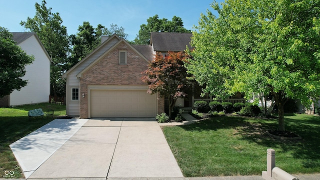 9831 Deering St, Fishers, IN 46037 - view of front of house featuring brick siding, driveway, and a front yard