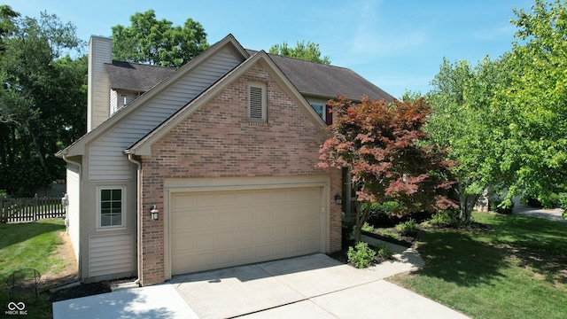 9831 Deering St, Fishers, IN 46037 - view of side of home with brick siding, a chimney, and driveway