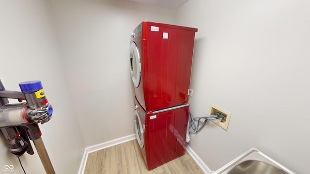 9831 Deering St, Fishers, IN 46037 - laundry area featuring stacked washer and clothes dryer and wood finished floors