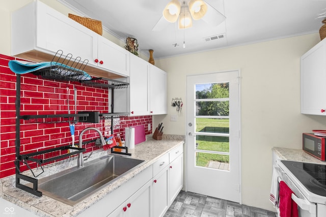 206 Allen Ln, Greenfield, IN 46140 - kitchen featuring black microwave, backsplash, white cabinetry, and crown molding