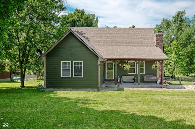 155 Hoover Dr, Princes Lakes, IN 46164 - view of front of home featuring a chimney, a patio, and roof with shingles