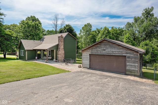 155 Hoover Dr, Princes Lakes, IN 46164 - view of front of house with a garage, an outdoor structure, a chimney, and a porch