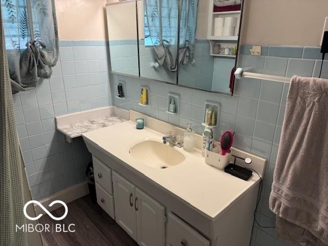 2830 Guilford Ave, Indianapolis, IN 46205 - bathroom featuring tile walls, vanity, and wainscoting