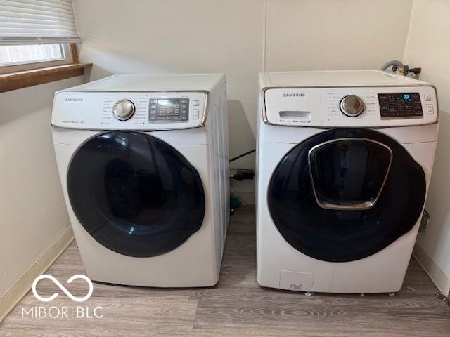 2830 Guilford Ave, Indianapolis, IN 46205 - washroom featuring independent washer and dryer and light wood-style flooring