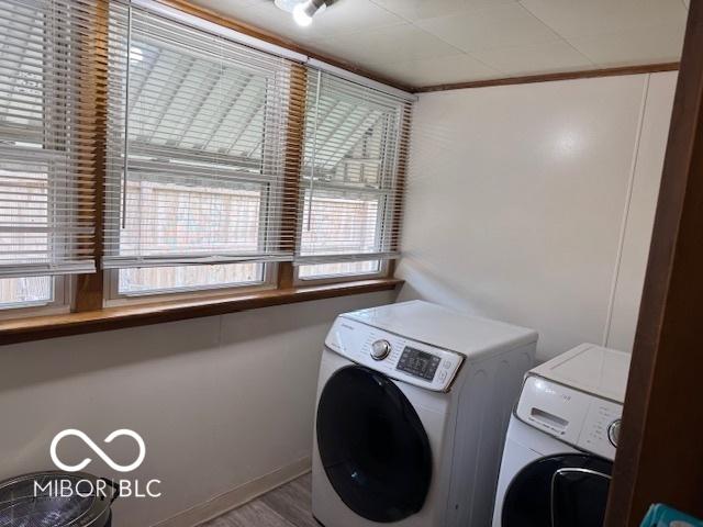 2830 Guilford Ave, Indianapolis, IN 46205 - laundry area featuring washing machine and dryer and ornamental molding