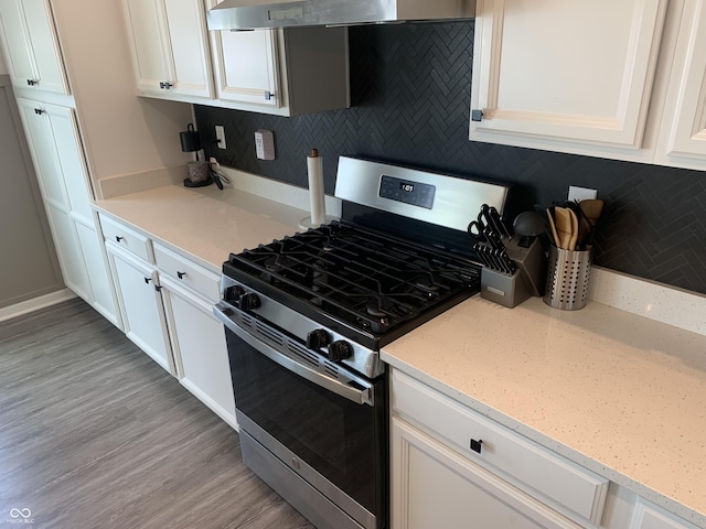7270 W Stone Pass, New Palestine, IN 46163 - kitchen with gas stove, decorative backsplash, exhaust hood, white cabinets, and light wood-type flooring