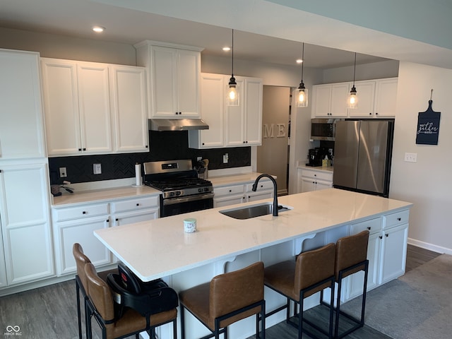 7270 W Stone Pass, New Palestine, IN 46163 - kitchen featuring stainless steel appliances, under cabinet range hood, white cabinets, tasteful backsplash, and recessed lighting