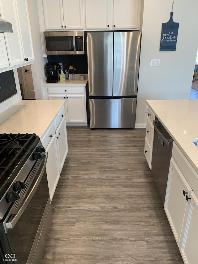 7270 W Stone Pass, New Palestine, IN 46163 - kitchen with stainless steel appliances, white cabinets, wood finished floors, light stone counters, and ventilation hood