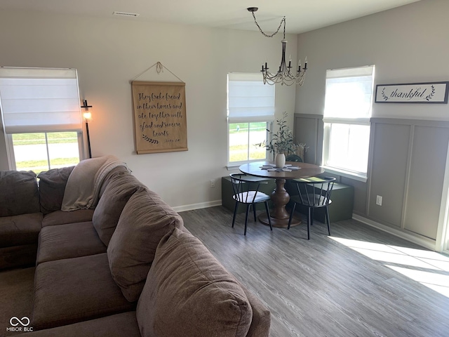 7270 W Stone Pass, New Palestine, IN 46163 - dining area featuring a chandelier, healthy amount of natural light, wood finished floors, and a wainscoted wall