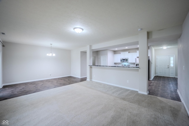 1336 Danielle Rd, Lebanon, IN 46052 - unfurnished living room with dark carpet, a chandelier, recessed lighting, and dark wood-style flooring