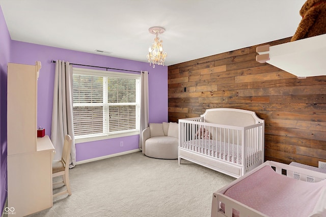 10587 Proposal Pointe Way, Fishers, IN 46040 - bedroom featuring wood walls, a chandelier, carpet flooring, and a nursery area