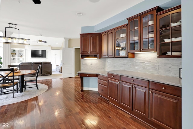 10587 Proposal Pointe Way, Fishers, IN 46040 - kitchen featuring ceiling fan, light countertops, glass insert cabinets, open floor plan, and dark wood-style floors