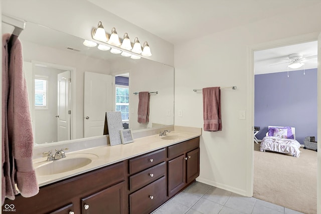 10587 Proposal Pointe Way, Fishers, IN 46040 - ensuite bathroom featuring double vanity, tile patterned floors, healthy amount of natural light, and a ceiling fan