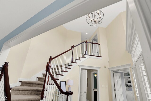 10587 Proposal Pointe Way, Fishers, IN 46040 - stairs featuring a high ceiling and a chandelier