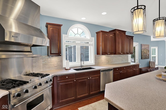 10587 Proposal Pointe Way, Fishers, IN 46040 - kitchen featuring appliances with stainless steel finishes, wall chimney range hood, light countertops, decorative light fixtures, and decorative backsplash