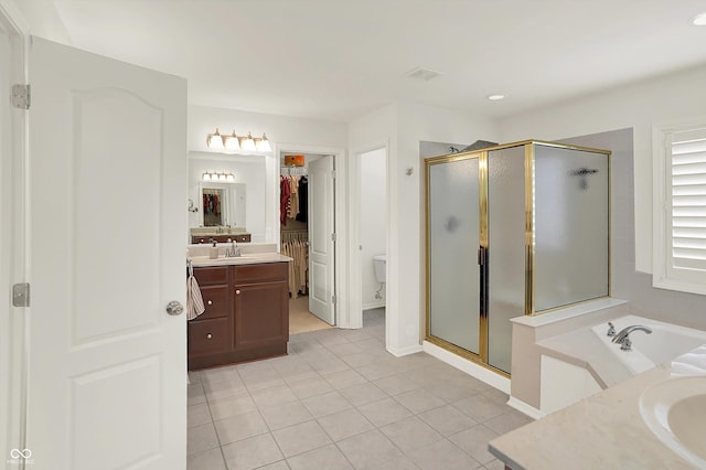 10587 Proposal Pointe Way, Fishers, IN 46040 - full bath featuring vanity, a shower stall, tile patterned floors, a garden tub, and recessed lighting