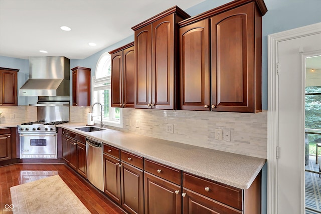 10587 Proposal Pointe Way, Fishers, IN 46040 - kitchen with wall chimney range hood, appliances with stainless steel finishes, dark wood-style flooring, light countertops, and recessed lighting