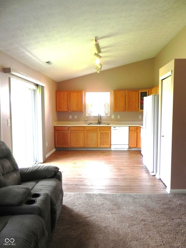 10178 Cornith Way, Avon, IN 46123 - kitchen featuring white appliances, vaulted ceiling, open floor plan, light countertops, and light wood-style flooring