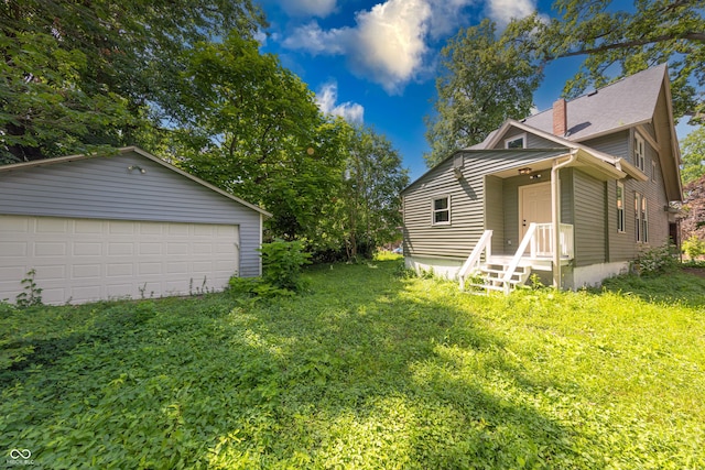5511 E University Ave, Indianapolis, IN 46219 - view of green lawn with a detached garage and an outdoor structure