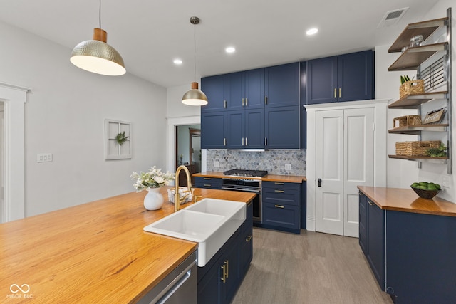 211 N County Line Rd, In, IN 47272 - kitchen with butcher block counters, blue cabinetry, open shelves, decorative backsplash, and light wood-style floors