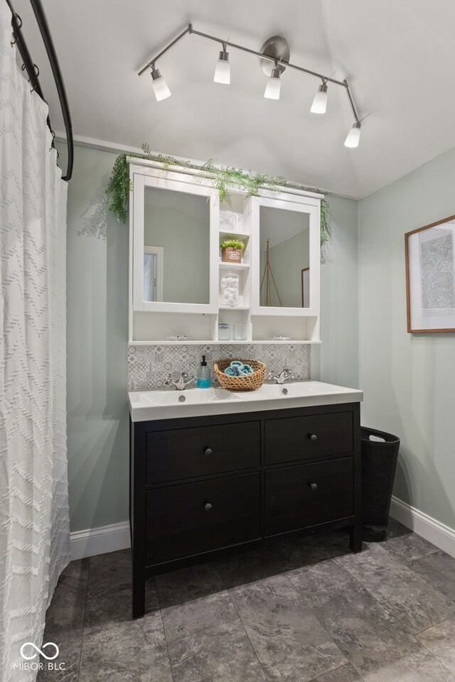 211 N County Line Rd, In, IN 47272 - bathroom with double vanity, track lighting, and backsplash