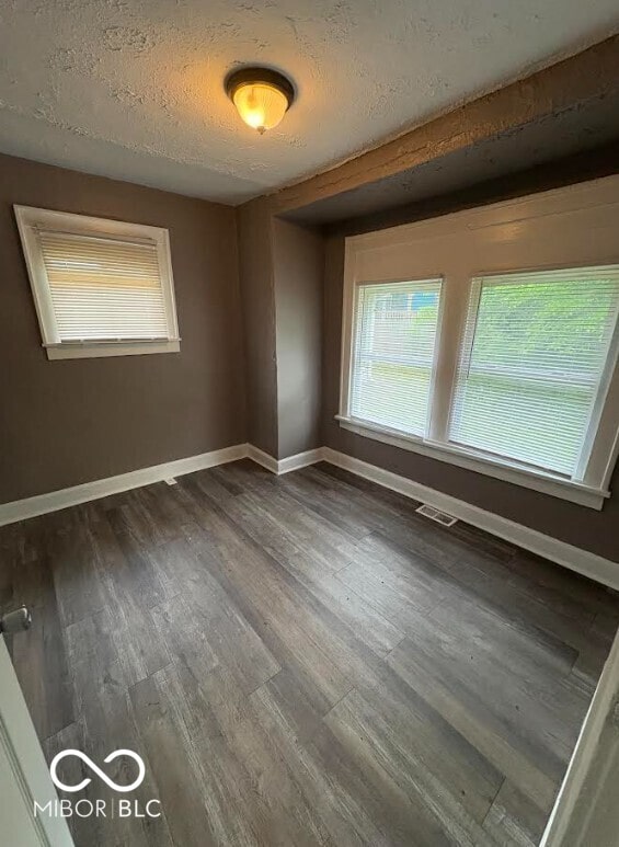 1521 N Tacoma Ave, Indianapolis, IN 46201 - spare room featuring dark wood-style floors and a textured ceiling