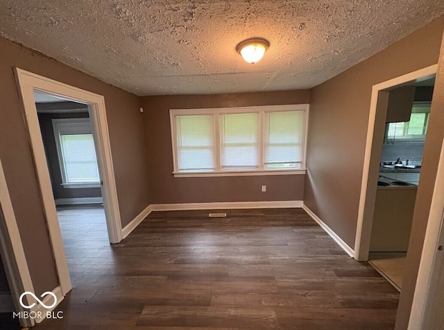 1521 N Tacoma Ave, Indianapolis, IN 46201 - unfurnished room with dark wood finished floors and a textured ceiling