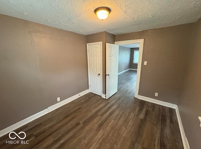 1521 N Tacoma Ave, Indianapolis, IN 46201 - unfurnished room featuring dark wood-type flooring and a textured ceiling