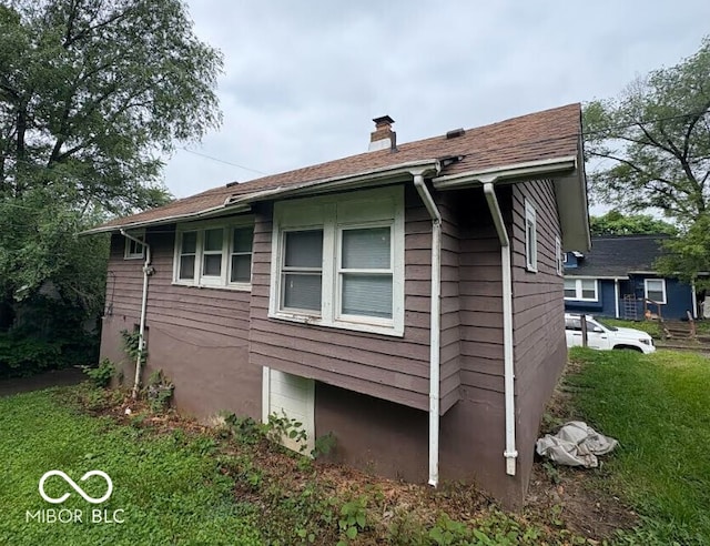 1521 N Tacoma Ave, Indianapolis, IN 46201 - view of side of property with a chimney and a lawn