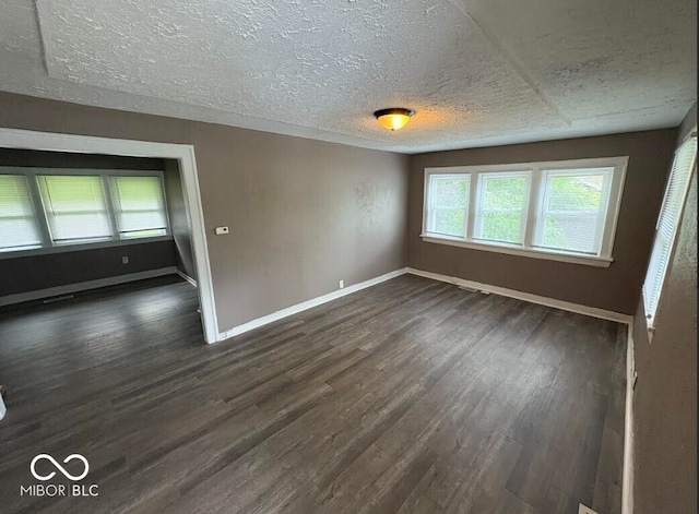 1521 N Tacoma Ave, Indianapolis, IN 46201 - unfurnished room with dark wood finished floors and a textured ceiling