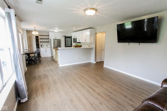 7710 Samuel Dr, Indianapolis, IN 46259 - unfurnished living room featuring light wood-style floors and baseboards