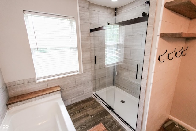 7710 Samuel Dr, Indianapolis, IN 46259 - full bathroom with a bath, a shower stall, healthy amount of natural light, and wood finished floors