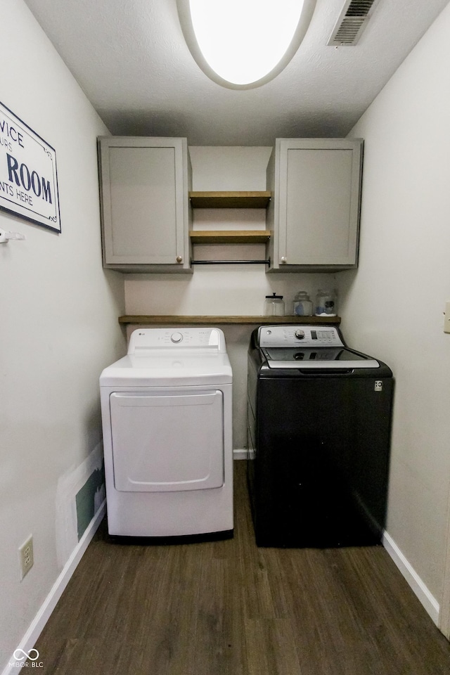 7710 Samuel Dr, Indianapolis, IN 46259 - laundry room with independent washer and dryer, cabinet space, and dark wood-style floors