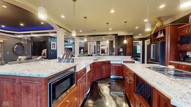 3306 Mullinix Rd, Greenwood, IN 46143 - kitchen featuring stainless steel appliances, ornate columns, open floor plan, a large island, and light stone countertops