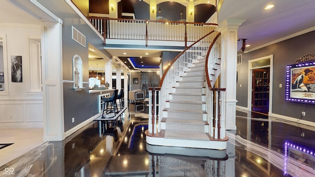 3306 Mullinix Rd, Greenwood, IN 46143 - staircase with ornate columns, crown molding, and recessed lighting