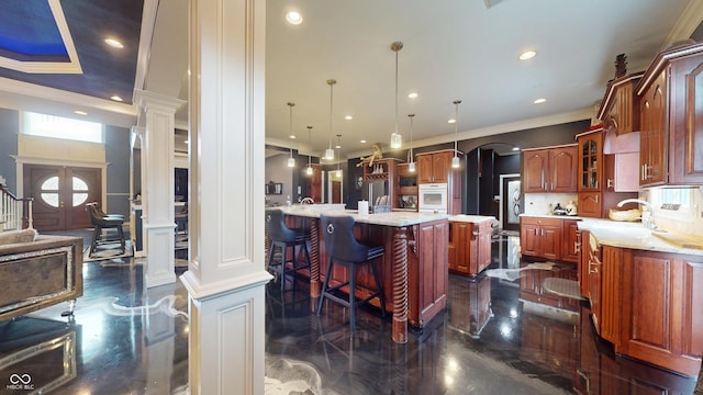 3306 Mullinix Rd, Greenwood, IN 46143 - kitchen with crown molding, decorative columns, a large island with sink, glass insert cabinets, and recessed lighting