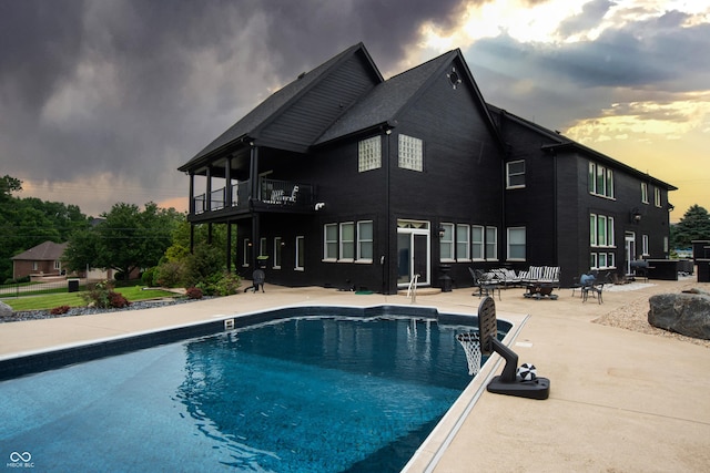 3306 Mullinix Rd, Greenwood, IN 46143 - pool at dusk with a patio area and an outdoor pool
