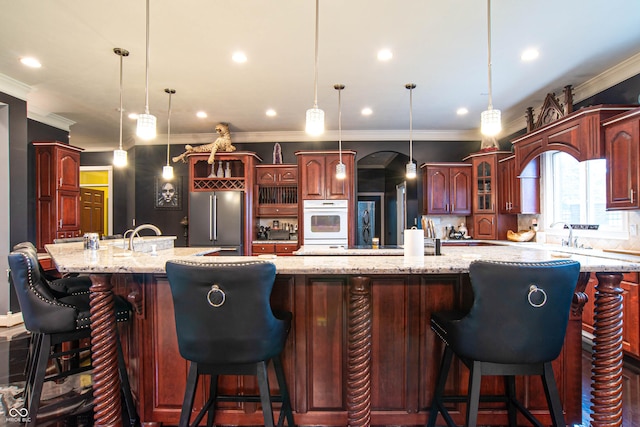 3306 Mullinix Rd, Greenwood, IN 46143 - kitchen with high end fridge, ornamental molding, a large island with sink, glass insert cabinets, and backsplash