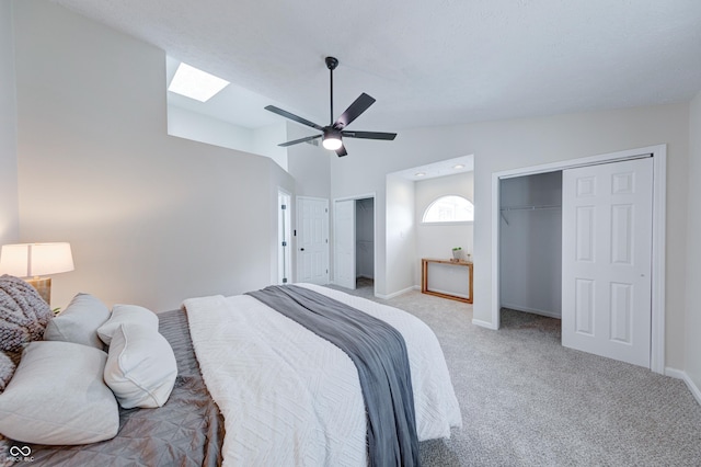 8178 Foxchase Cir, Indianapolis, IN 46256 - bedroom with two closets, a skylight, light carpet, lofted ceiling, and a ceiling fan
