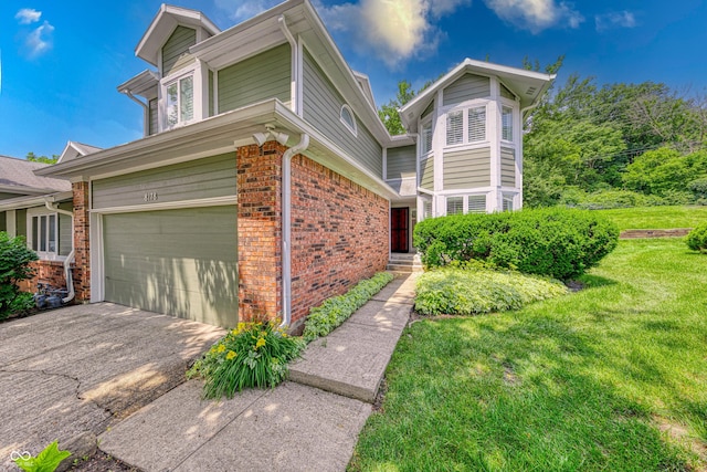 8178 Foxchase Cir, Indianapolis, IN 46256 - view of property exterior with brick siding, an attached garage, a yard, and driveway