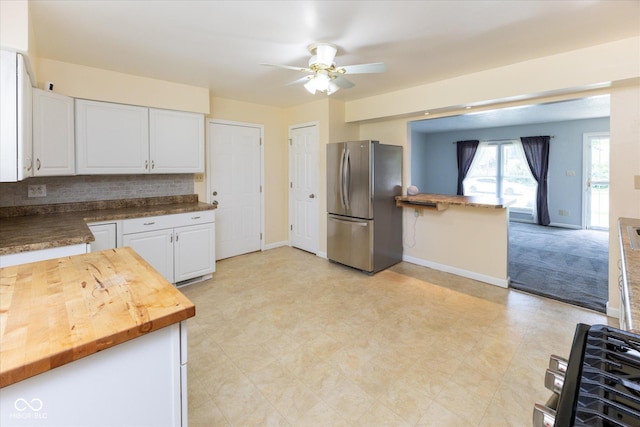 220 E Tilden Dr, Brownsburg, IN 46112 - kitchen featuring freestanding refrigerator, white cabinetry, a ceiling fan, butcher block counters, and light flooring