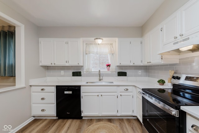 49 Druid Hill Ct Unit 0, Carmel, IN 46032 - kitchen featuring black dishwasher, stainless steel electric stove, light wood-style floors, under cabinet range hood, and white cabinets